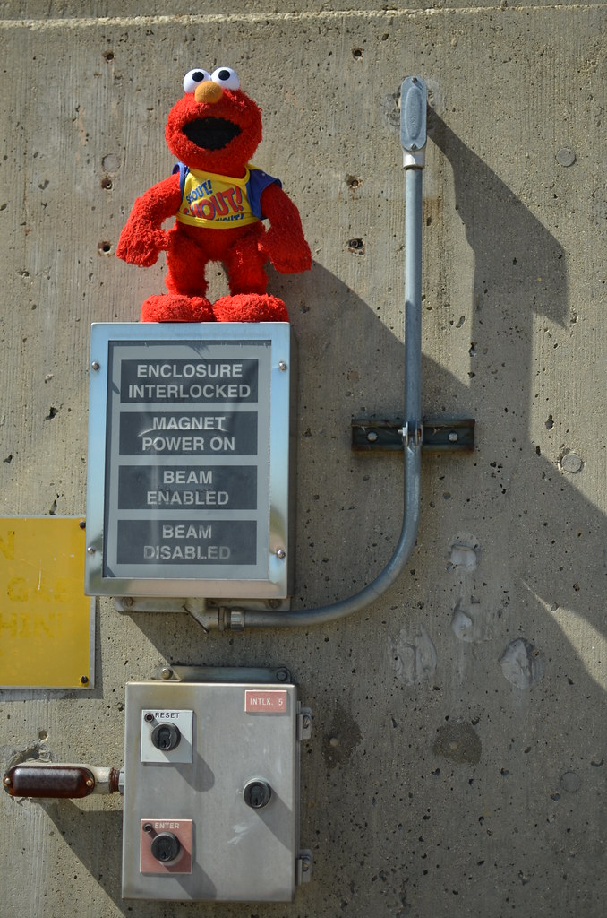 Elmo on Fermilab Tevatron Particle Accelerator Status Sign